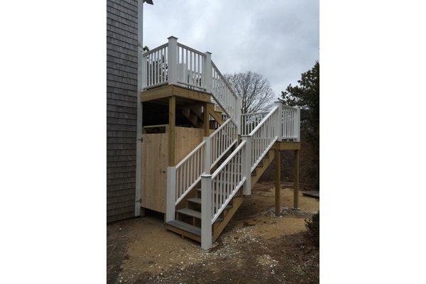 Outdoor shower and stairs leading to second floor deck